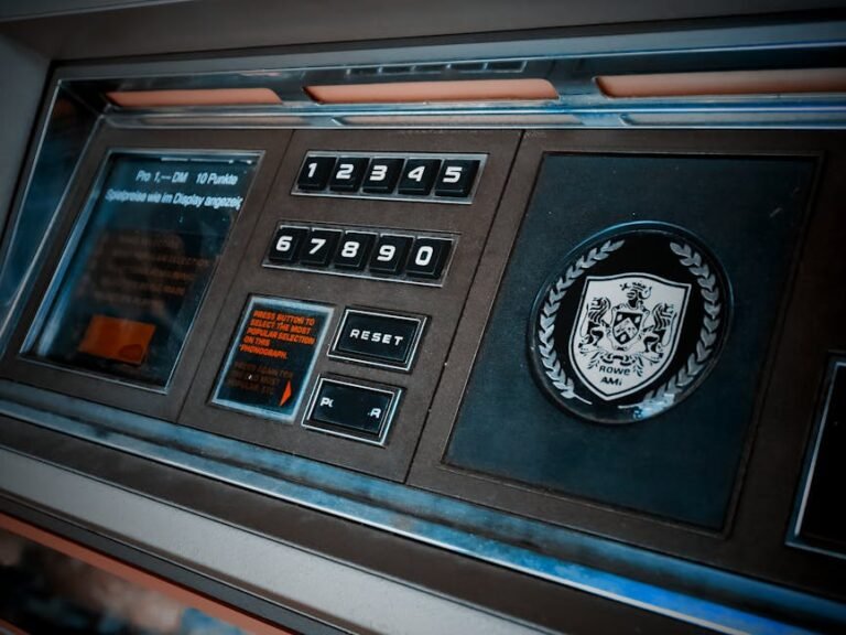 Close-up of a vintage arcade machine control panel with numeric keypad and emblem.