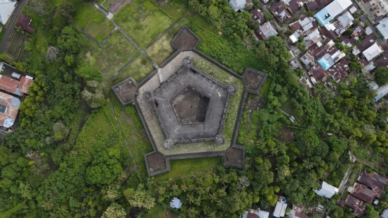 A striking aerial view of Fort Belgica, showcasing its geometric design amidst green surroundings.