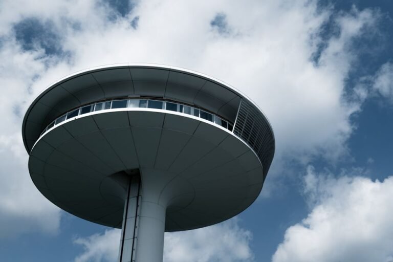 Modern UFO-like structure in Hamburg, Germany, stands boldly against a cloud-dotted blue sky.