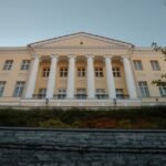 Historic Stenbock House, a neoclassical gem in Tallinn, Estonia, under clear autumn skies.