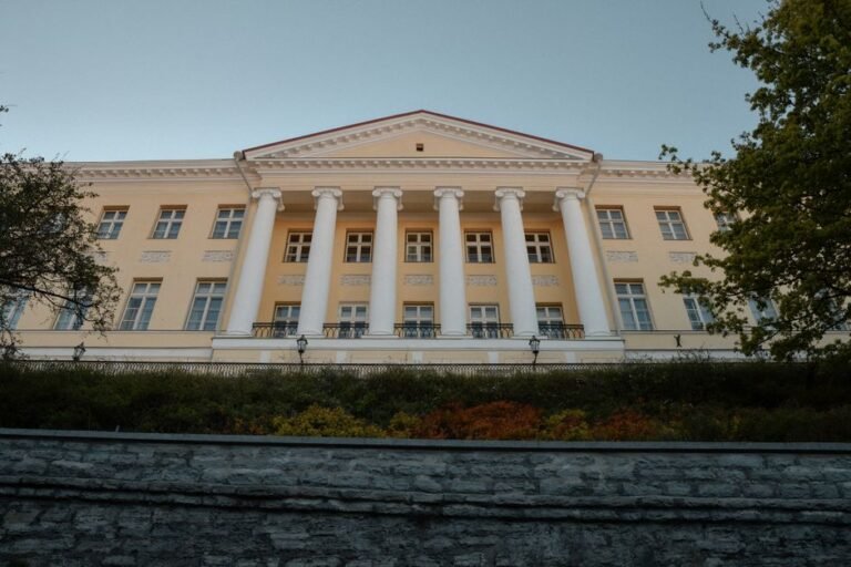 Historic Stenbock House, a neoclassical gem in Tallinn, Estonia, under clear autumn skies.