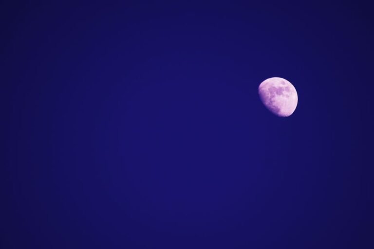 Captivating image of the moon shining brightly in a clear deep blue night sky.