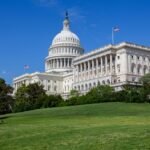 Stunning photo of the United States Capitol under a clear blue sky, showcasing neoclassical architecture.