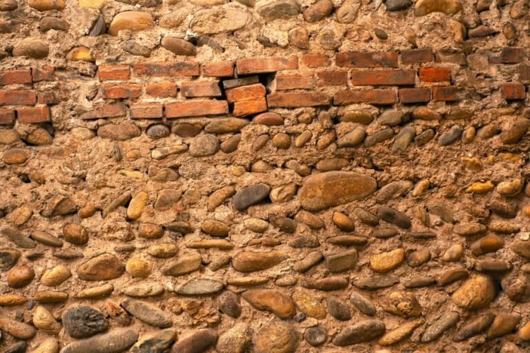 Close-up of a rustic stone and brick wall with natural textures and colors.